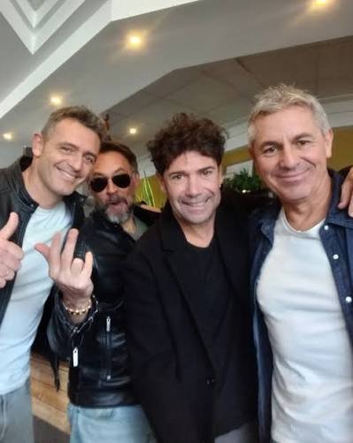 Los cuatro miembros de Los Cucas en la actualidad, sonriendo en un selfie dentro de un local